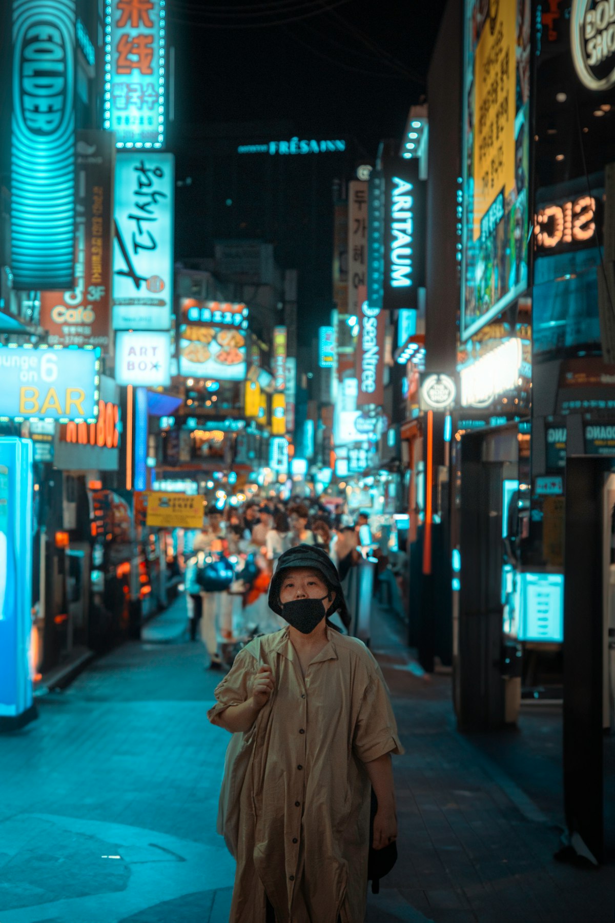 Myeongdong street at night lined with ARITAUM and ARTBOX beauty shop signs