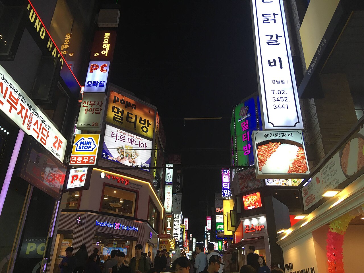 Night street in Yeoksam-dong, Gangnam, lined with Korean restaurant and PC-bang signs
