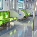 Empty Seoul subway car with green seats and blue hand straps
