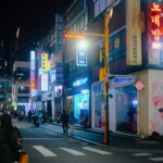 Seoul street corner at night with a GS25 and a neon noraebang sign