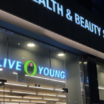 Lit Olive Young health and beauty store sign on a Korean shopping street