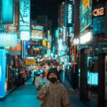 Myeongdong street at night lined with ARITAUM and ARTBOX beauty shop signs
